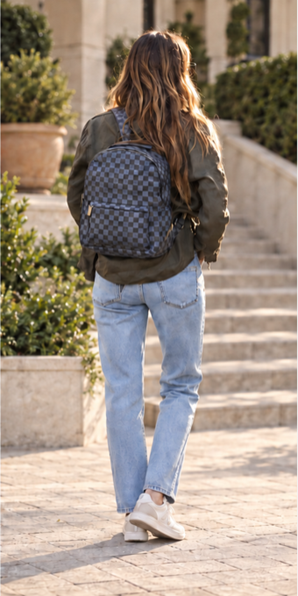 Woman carrying a checkered Daisy Rose backpack